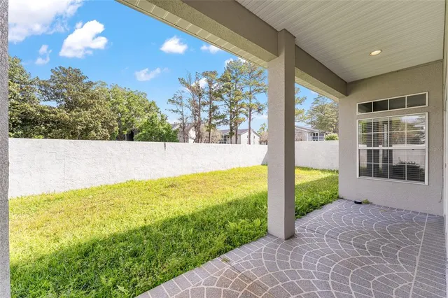 a view of yard with swimming pool and green space