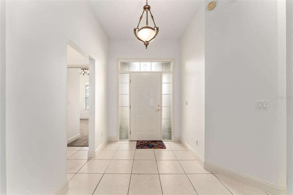 3003 Southwest 41st Place Ocala, FL 34474 - Photo 7 of 51 a view of an empty room with wooden floor and windows