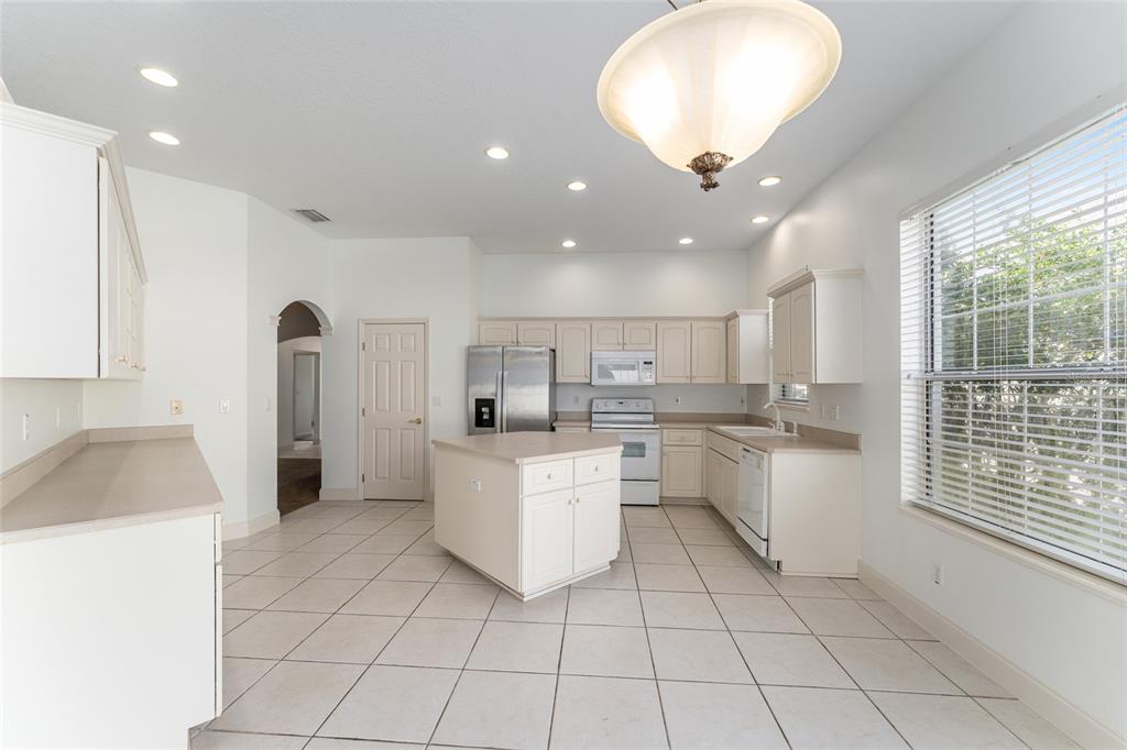3003 Southwest 41st Place Ocala, FL 34474 - Photo 10 of 51 a kitchen with a sink a counter top space cabinets and stainless steel appliances