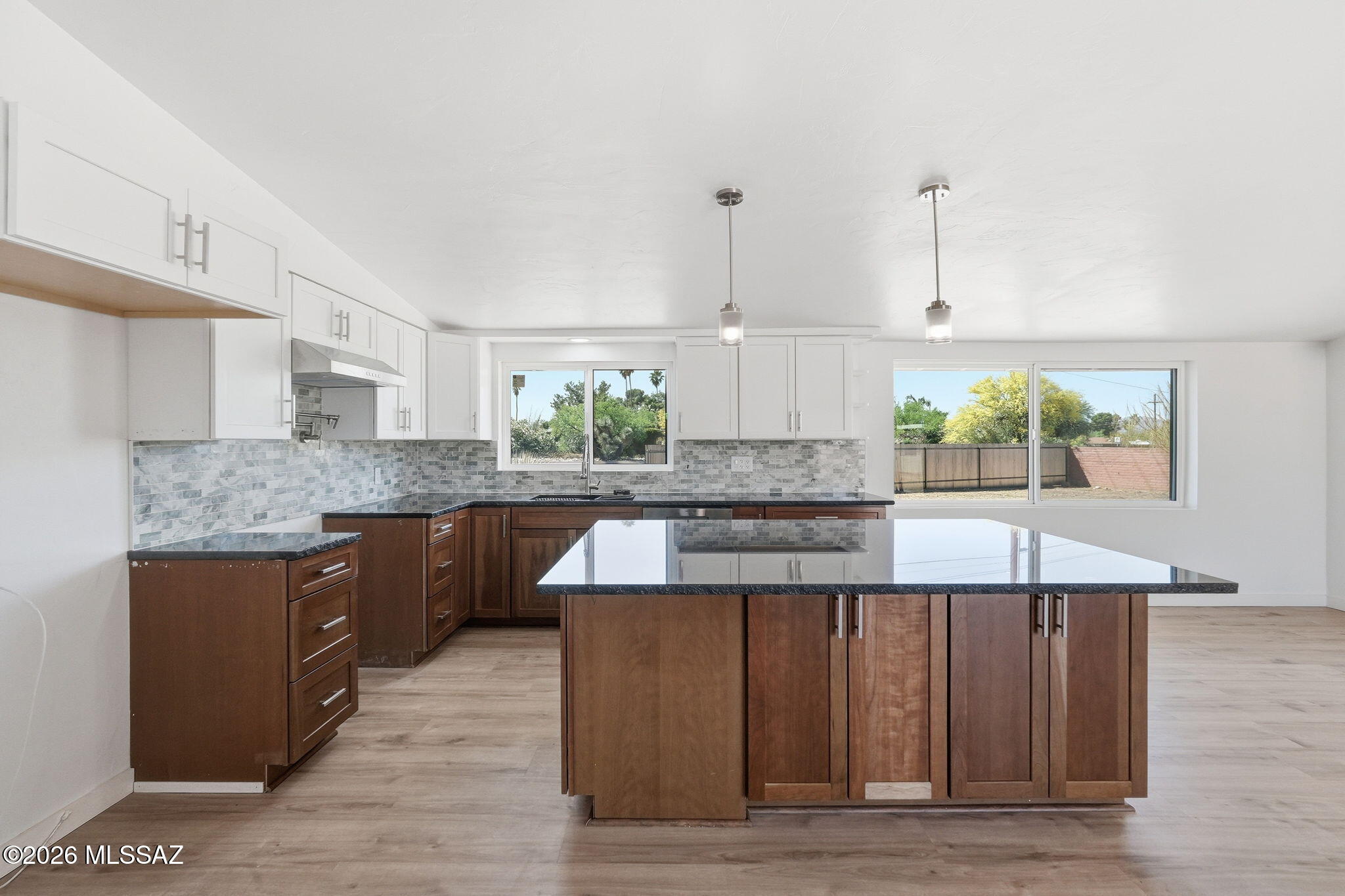 950 West Ina Road Tucson, AZ 85704 - Photo 9 of 54 a kitchen with stainless steel appliances granite countertop wooden cabinets and sink