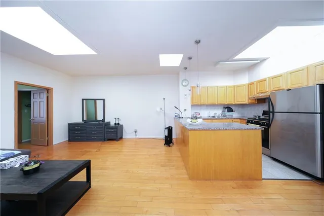a room with wooden floor and furniture