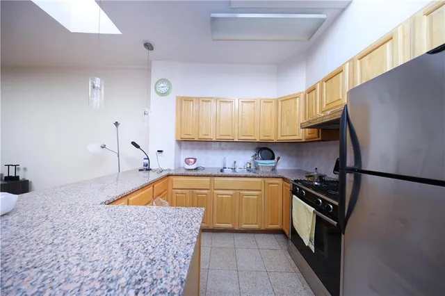a view of a room with wooden floor and fan