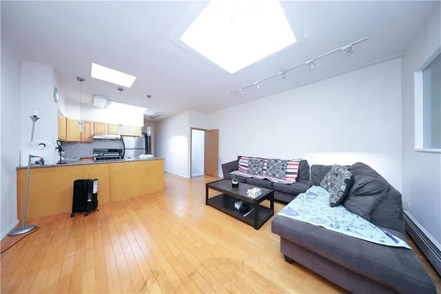 a kitchen with stainless steel appliances granite countertop a refrigerator a stove and a sink