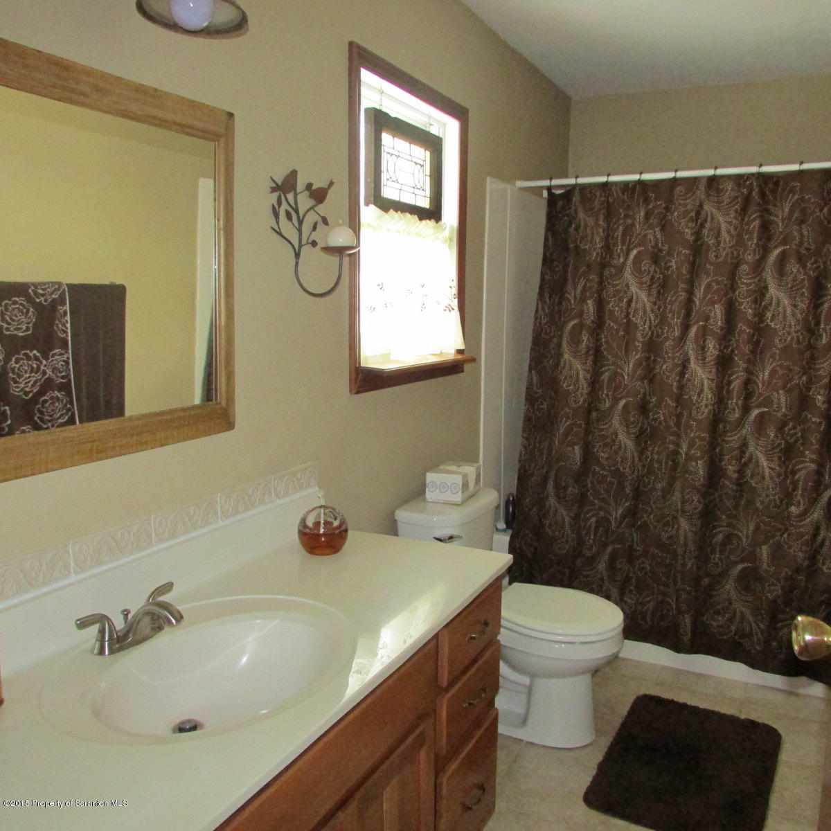 73 Taylor Road Montrose, PA 18801 - Photo 17 of 26 a bathroom with a sink a toilet and shower curtain