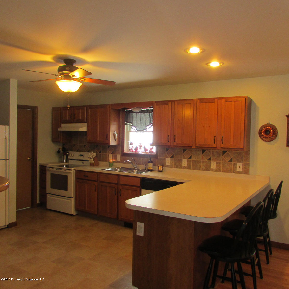 73 Taylor Road Montrose, PA 18801 - Photo 8 of 26 a kitchen with stainless steel appliances granite countertop a sink a stove a refrigerator and island