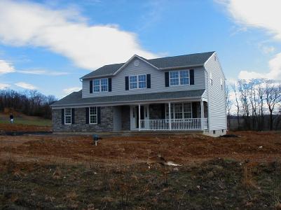 great covered porch,lovely setting, spacious, quality constructed home.