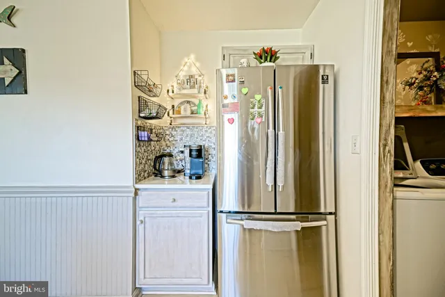 a kitchen with stainless steel appliances a refrigerator and cabinets
