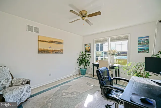 a bedroom with a bed and dresser with mirror