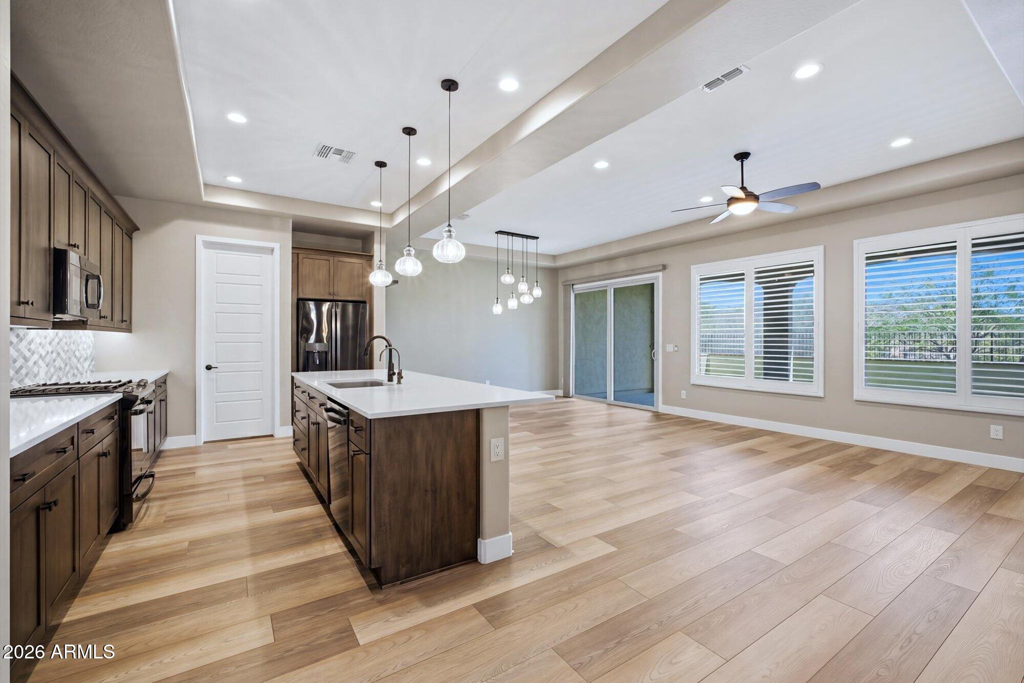 16849 West Merrell Street Goodyear, AZ 85395 - Photo 7 of 35 a kitchen with wooden floors and a sink