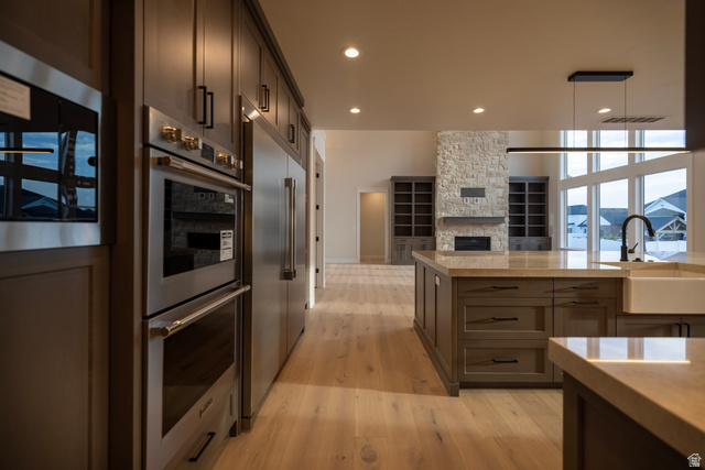 904 South 1900 West Layton, UT 84041 - Photo 19 of 19 Kitchen featuring stainless steel appliances, light tiled finished floors, open floor plan, and dark wood finish cabinets