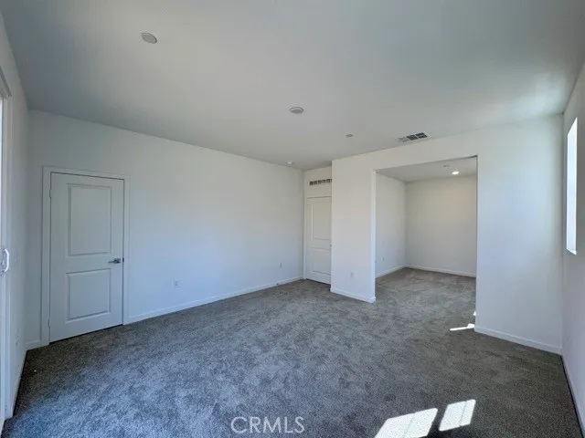 an empty room with windows and entrance