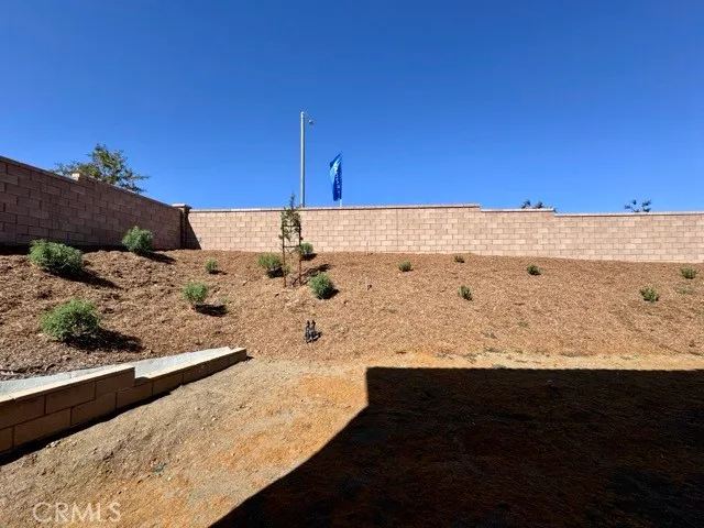 a view of a water with lawn chairs and a big yard