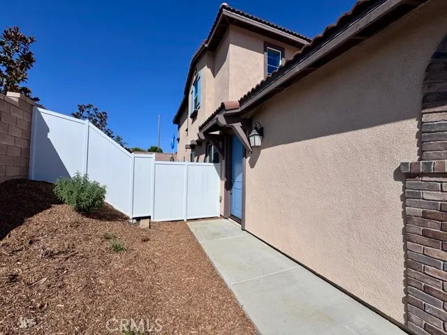a backyard of a house with wooden fence