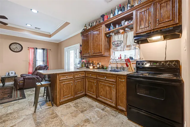 a kitchen with stainless steel appliances granite countertop a stove and cabinets