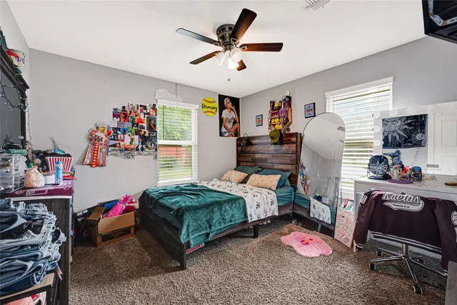 a bedroom with bed and a chandelier