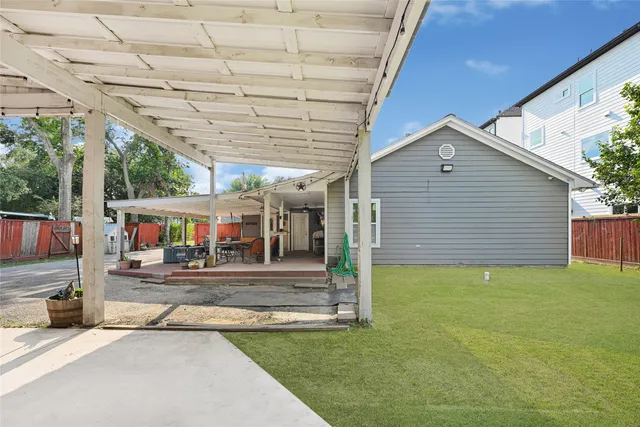 a view of a patio with a table and chairs under an umbrella
