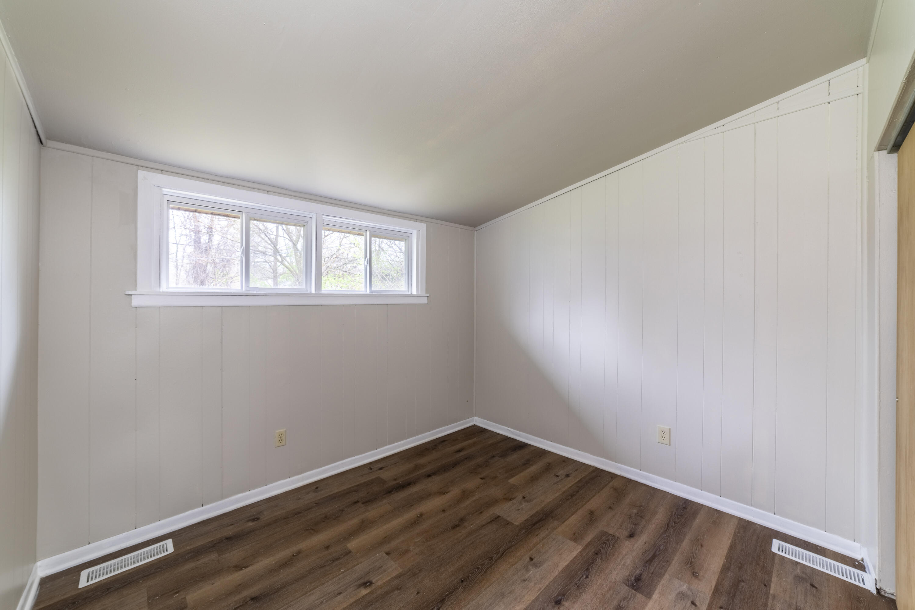 2280 Roosevelt Place Gary, IN 46404 - Photo 11 of 14 a view of an empty room with wooden floor and a window