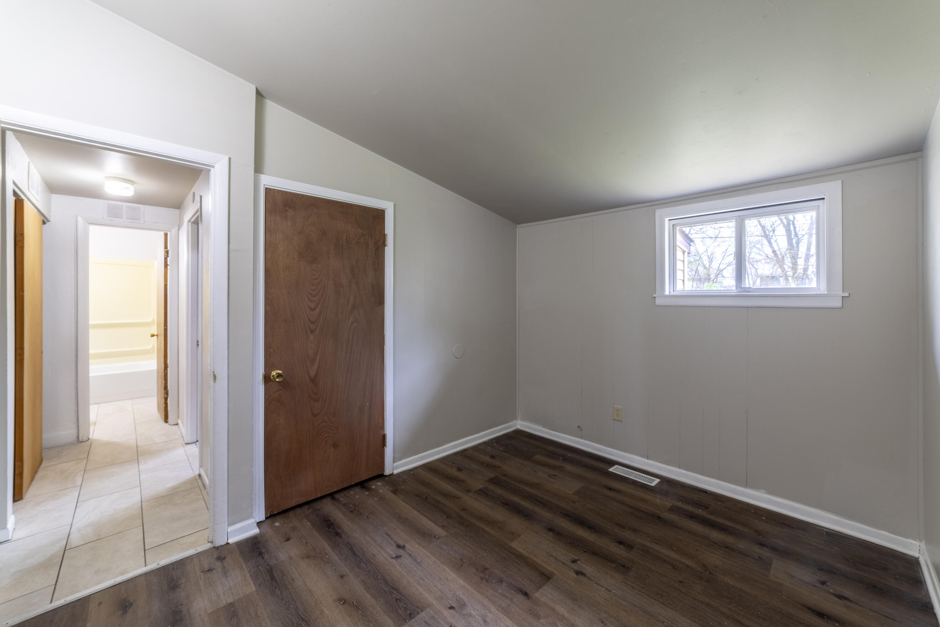 2280 Roosevelt Place Gary, IN 46404 - Photo 12 of 14 an empty room with wooden floor and windows