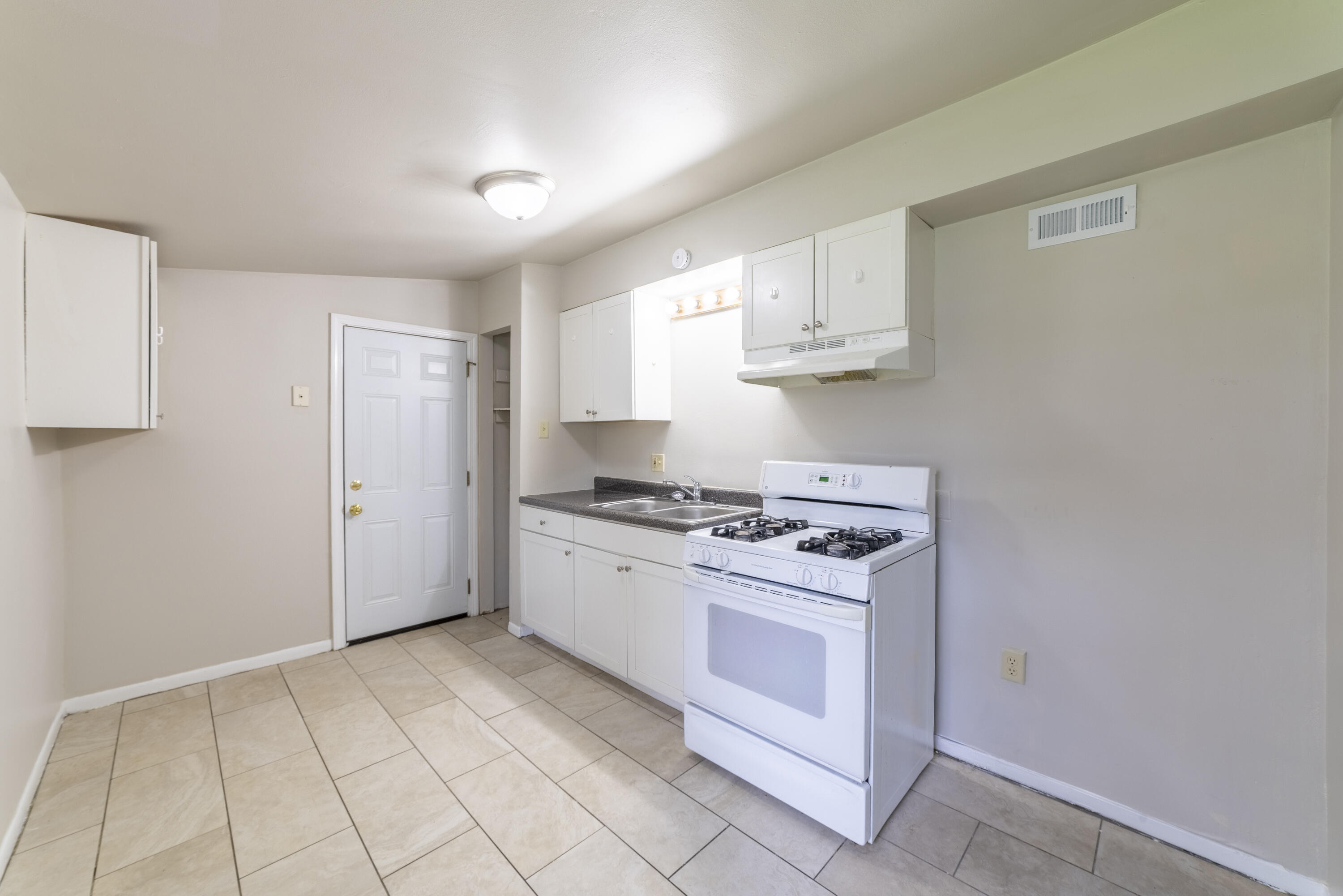 2280 Roosevelt Place Gary, IN 46404 - Photo 6 of 14 a kitchen with cabinets appliances and a window