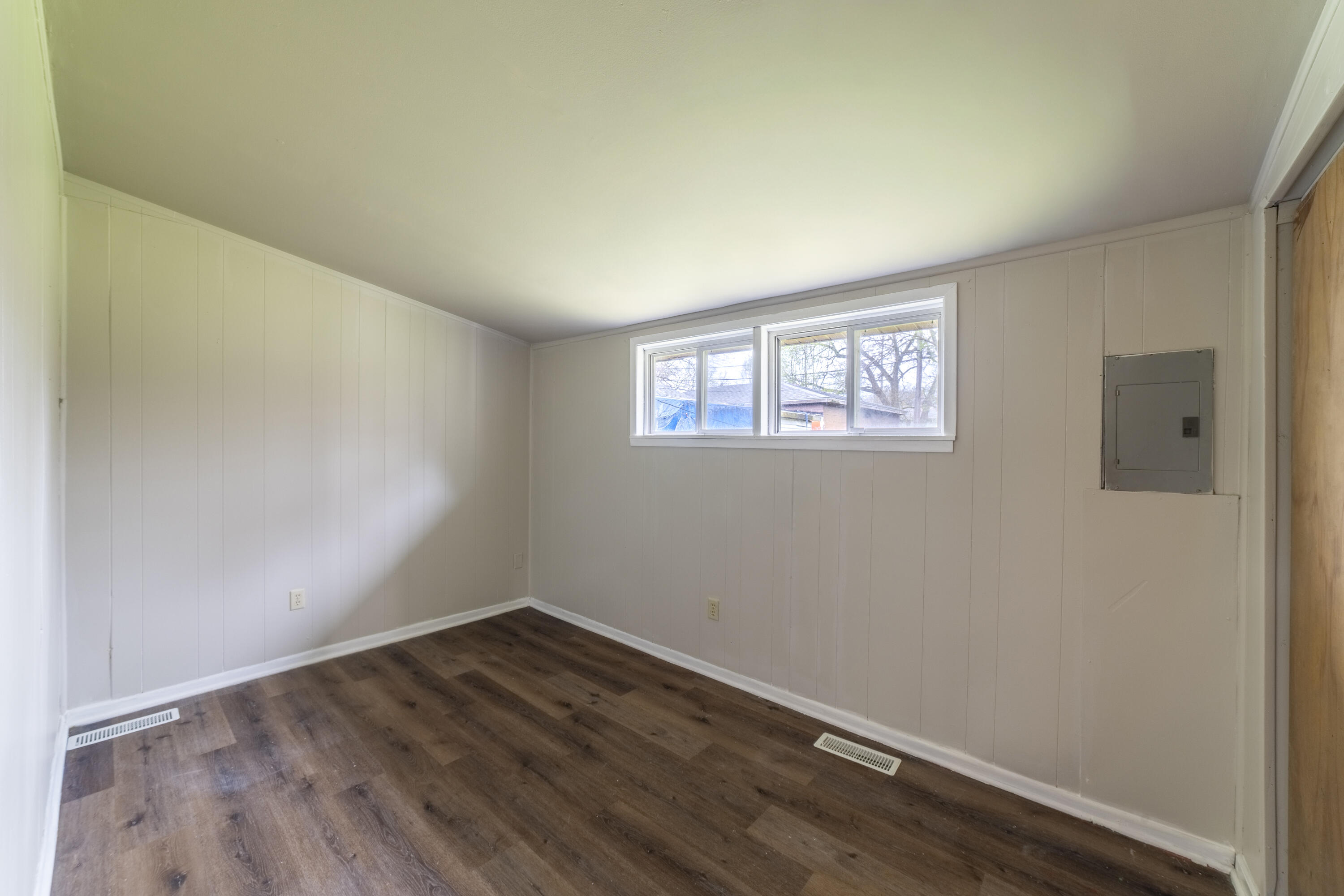 2280 Roosevelt Place Gary, IN 46404 - Photo 8 of 14 an empty room with wooden floor and windows