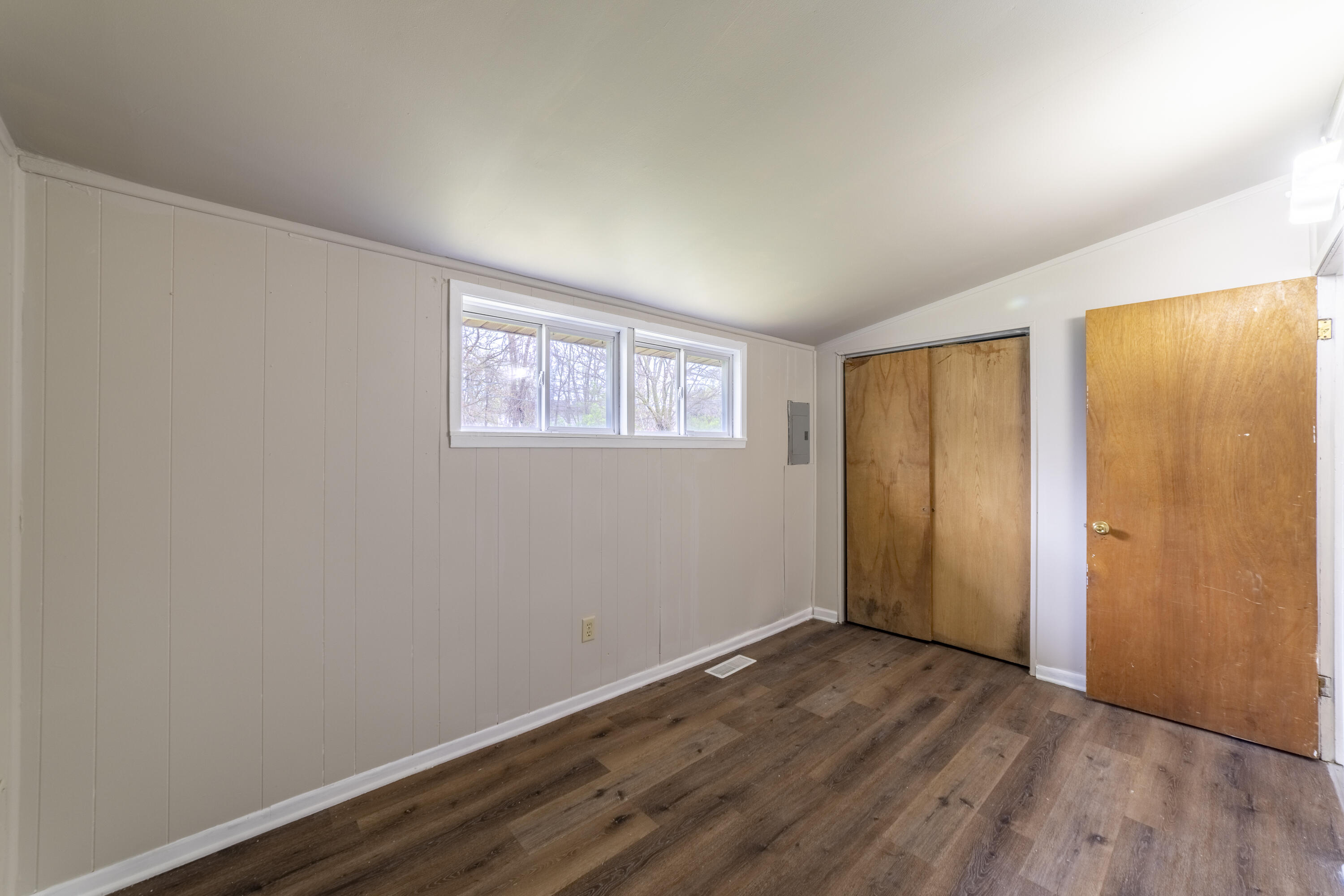2280 Roosevelt Place Gary, IN 46404 - Photo 9 of 14 an empty room with wooden floor and windows
