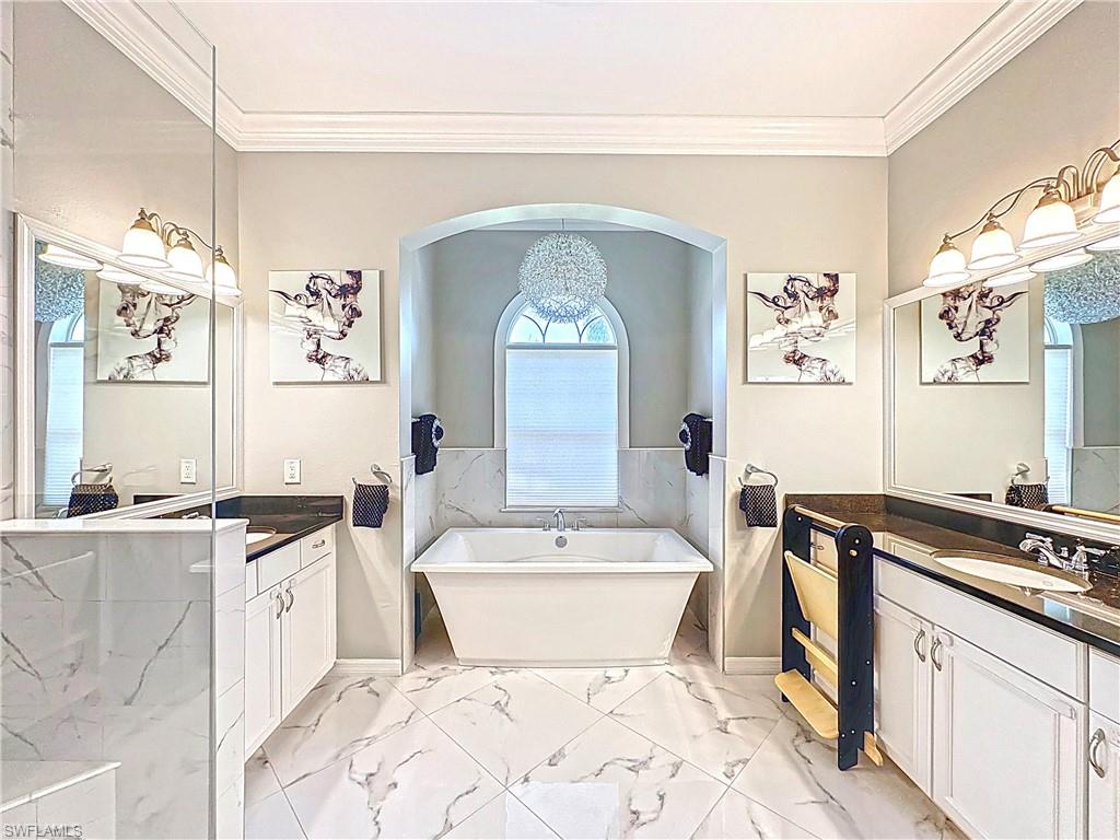 3032 Via Rialto Street Fort Myers, FL 33905 - Photo 10 of 26 a spacious bathroom with a bathtub sink mirror and toilet