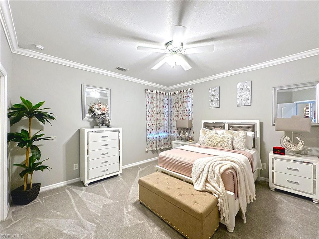 3032 Via Rialto Street Fort Myers, FL 33905 - Photo 17 of 26 a bedroom with a bed and a chandelier