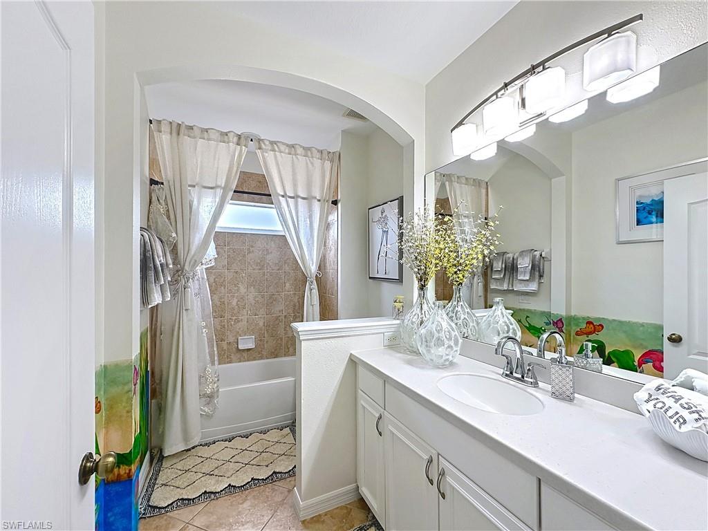 3032 Via Rialto Street Fort Myers, FL 33905 - Photo 20 of 26 a bathroom with a granite countertop sink a toilet and shower