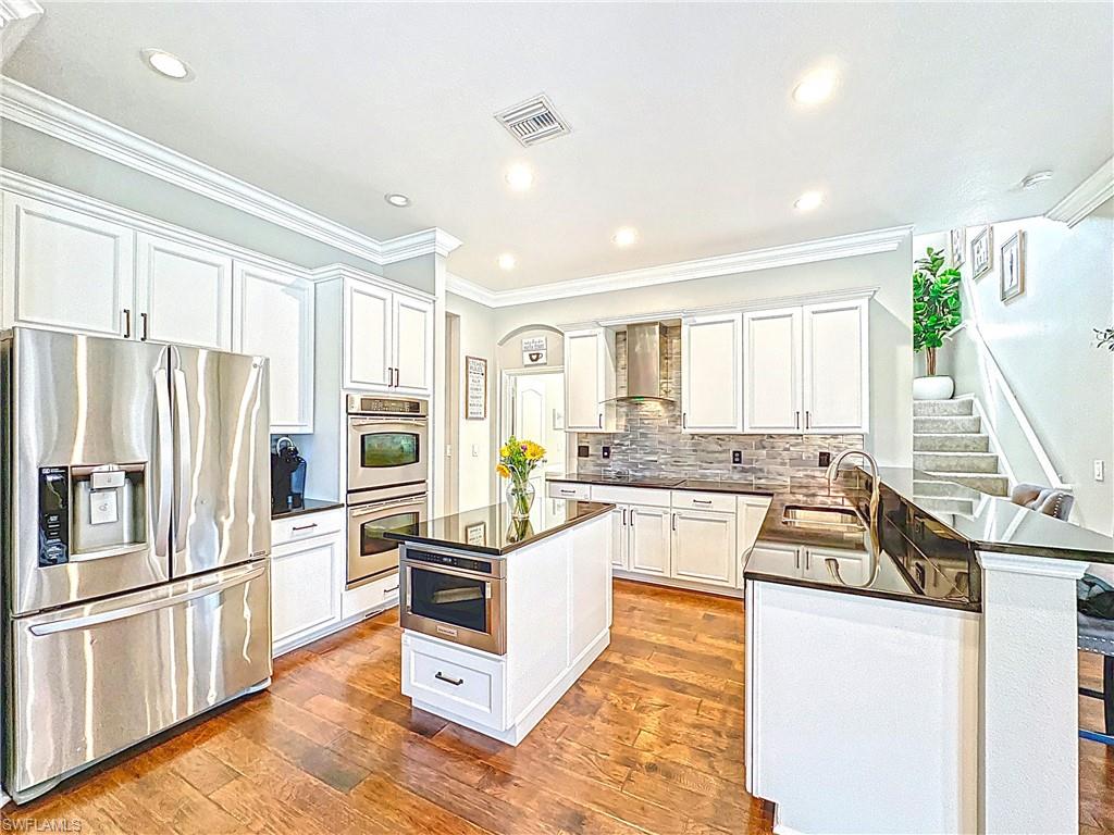 3032 Via Rialto Street Fort Myers, FL 33905 - Photo 4 of 26 a kitchen with white cabinets and stainless steel appliances