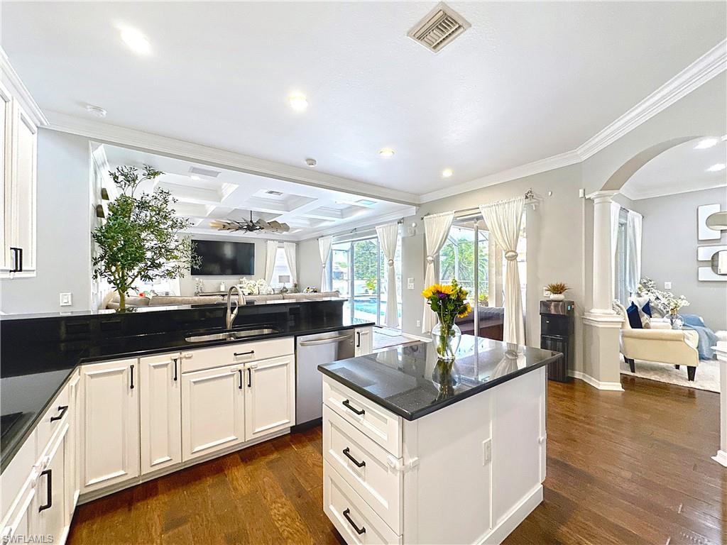 3032 Via Rialto Street Fort Myers, FL 33905 - Photo 26 of 26 a kitchen with granite countertop a sink and white cabinets with wooden floor
