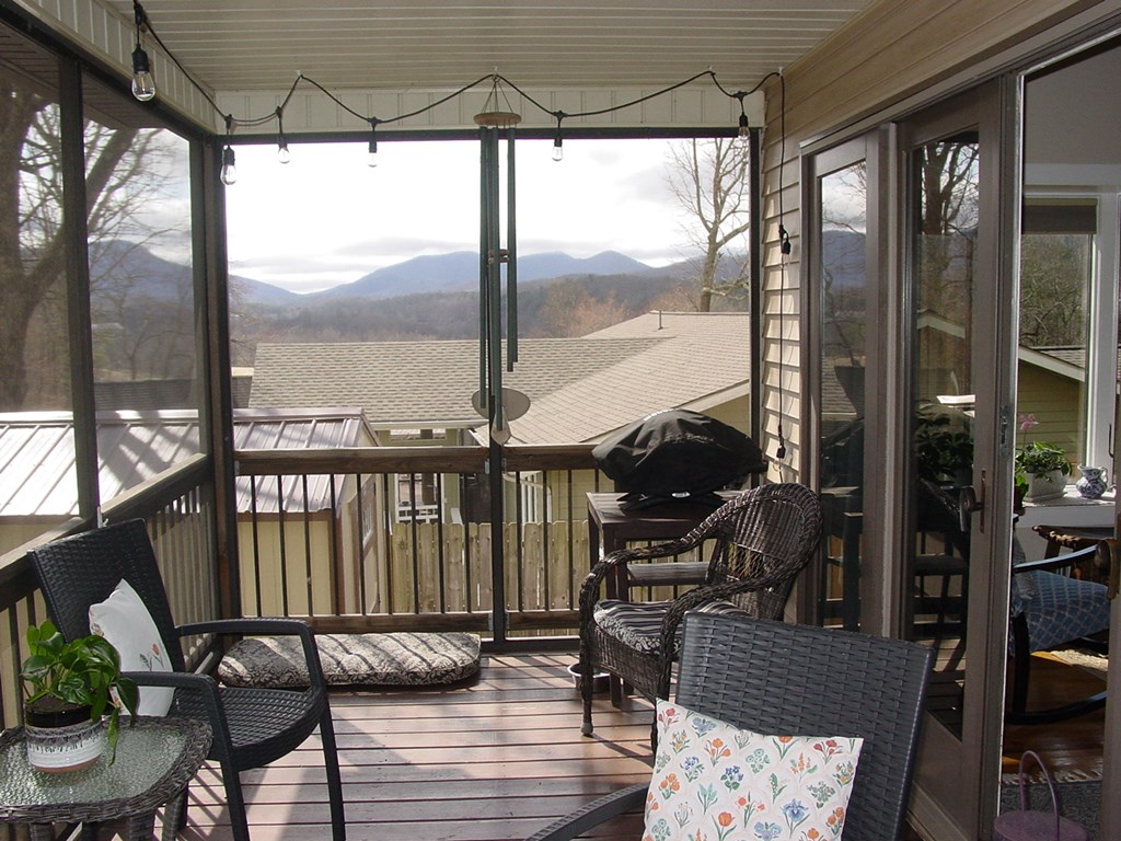 5170 Pine Crest Road Young Harris, GA 30582 - Photo 15 of 46 a view of a balcony with chairs and wooden floor