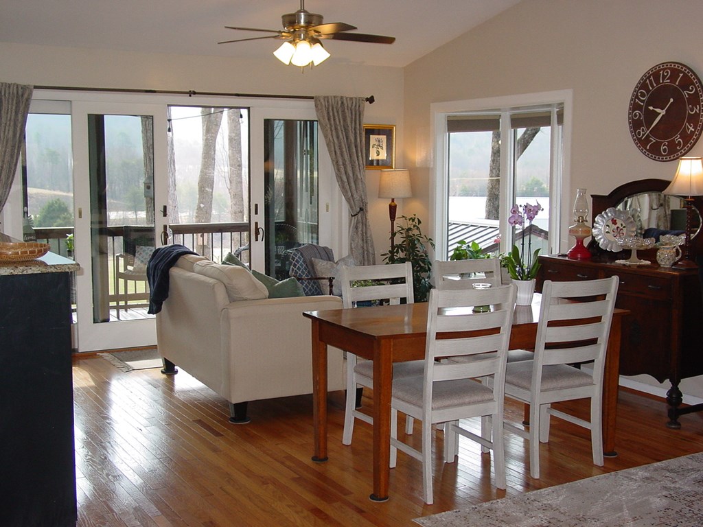 5170 Pine Crest Road Young Harris, GA 30582 - Photo 17 of 46 a view of a dining room with furniture large windows and wooden floor