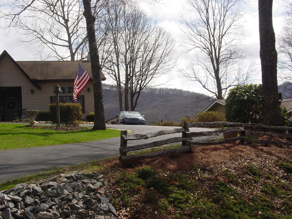 5170 Pine Crest Road Young Harris, GA 30582 - Photo 2 of 46 a backyard of a house with barbeque and wooden fence