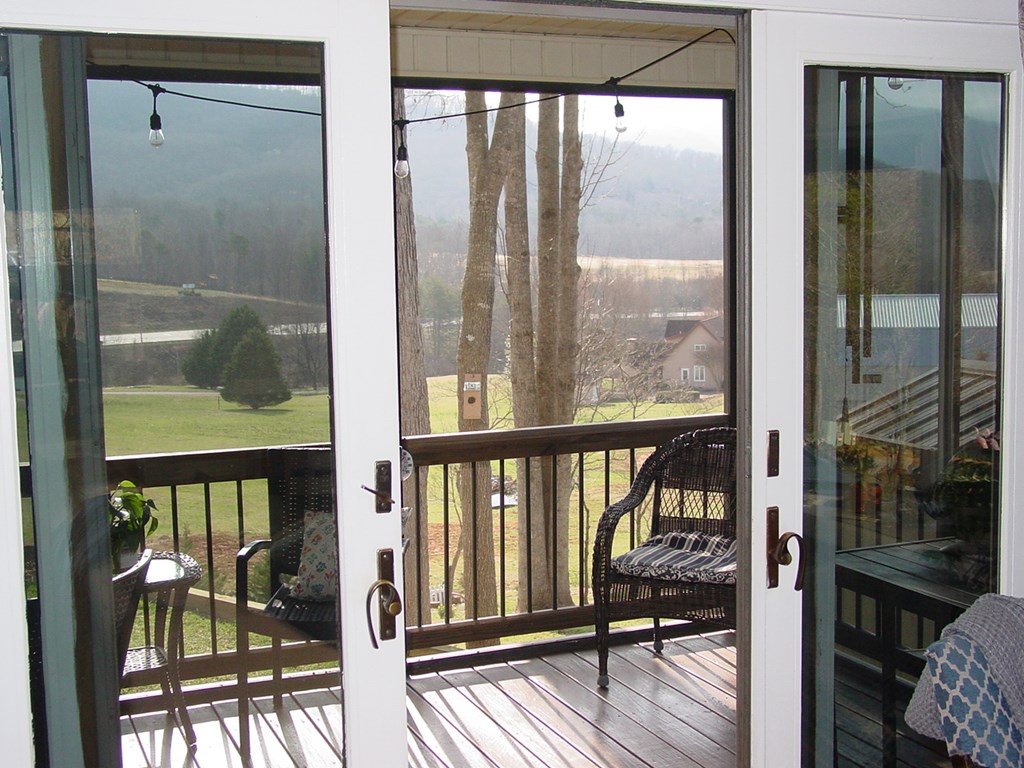5170 Pine Crest Road Young Harris, GA 30582 - Photo 22 of 46 a view of a balcony with chairs and wooden floor