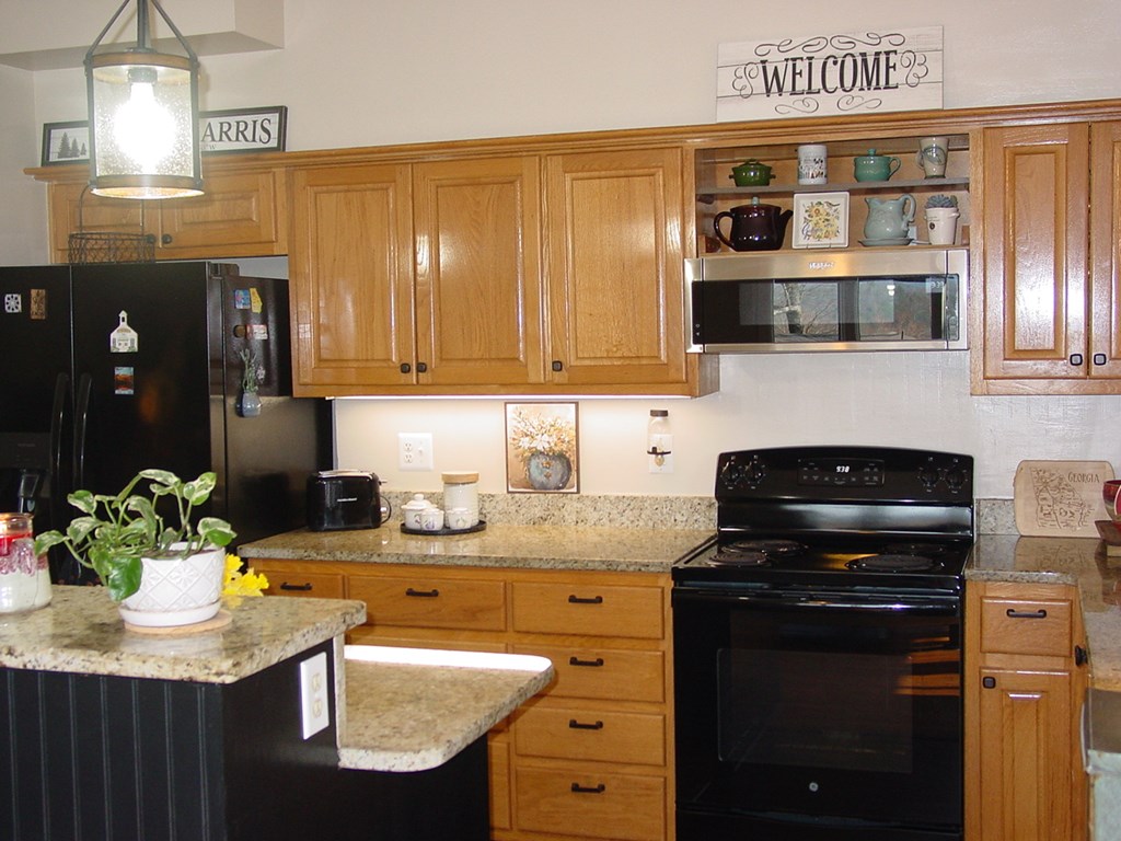 5170 Pine Crest Road Young Harris, GA 30582 - Photo 23 of 46 a kitchen with stainless steel appliances granite countertop a sink stove and cabinets