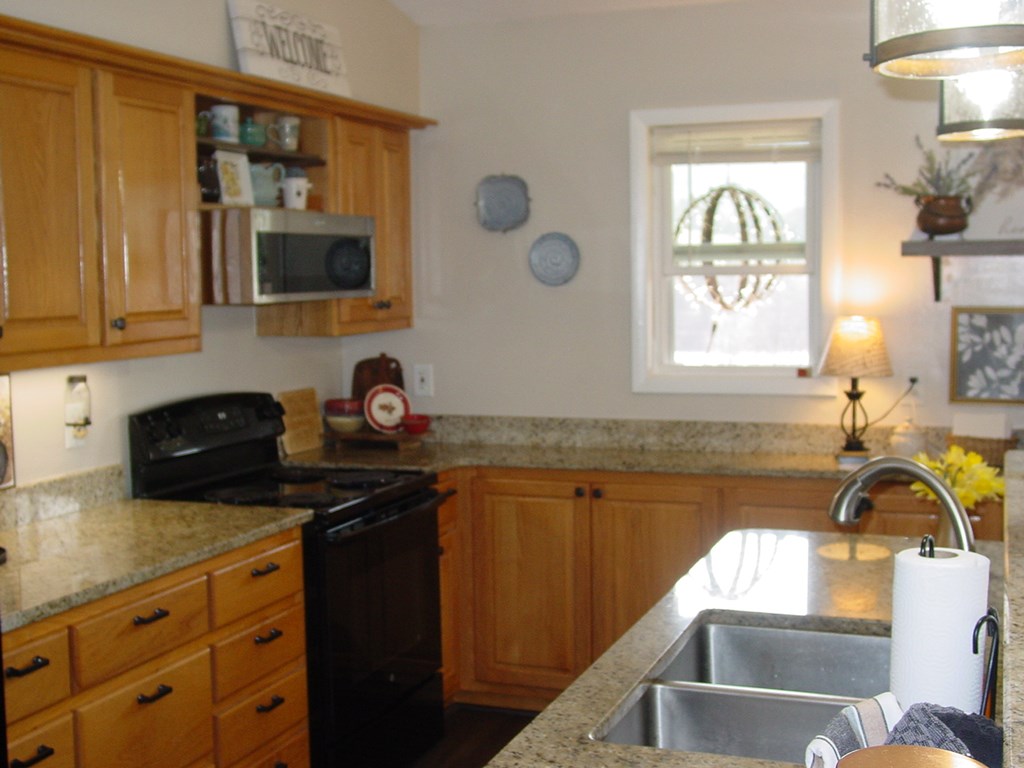 5170 Pine Crest Road Young Harris, GA 30582 - Photo 24 of 46 a kitchen with granite countertop a sink stainless steel appliances a window and a counter top space