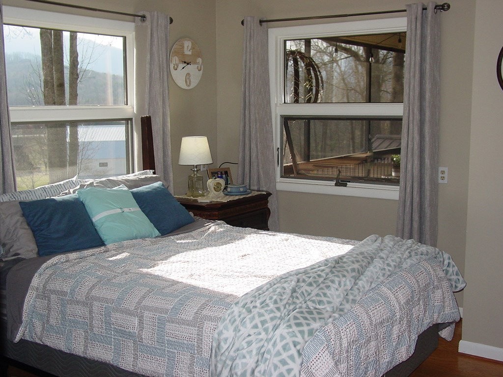 5170 Pine Crest Road Young Harris, GA 30582 - Photo 29 of 46 a bedroom with a large bed and a window
