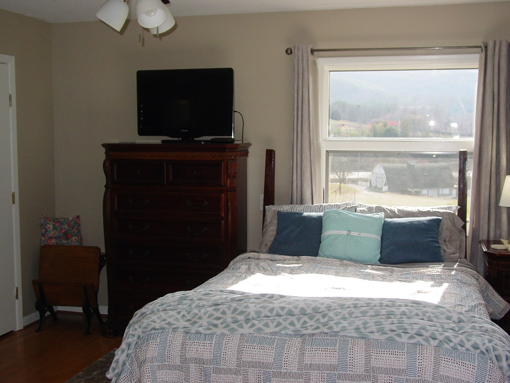 5170 Pine Crest Road Young Harris, GA 30582 - Photo 32 of 46 a bedroom with a bed and a window