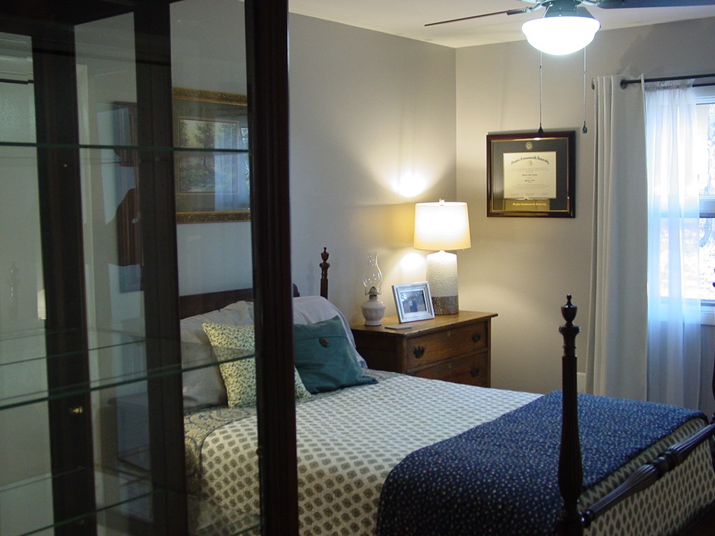 5170 Pine Crest Road Young Harris, GA 30582 - Photo 43 of 46 a bedroom with a bed and a lamp