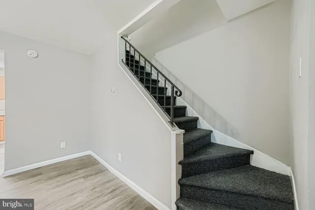 a view of entryway and hall with wooden floor