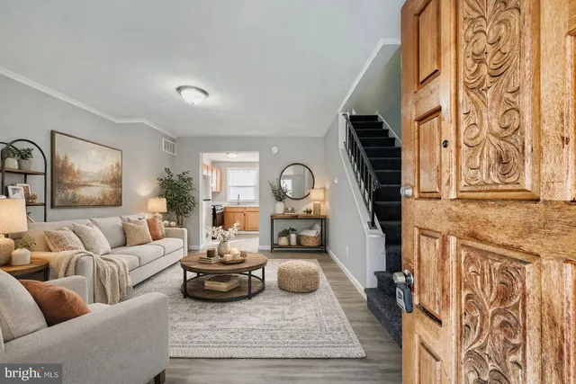 a living room with furniture fireplace and a window