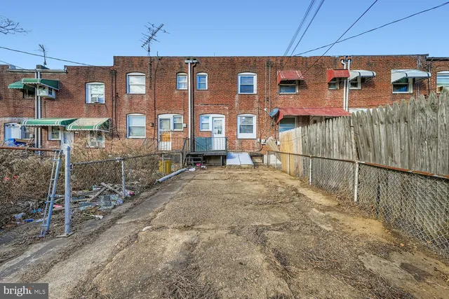a view of a brick house with many windows