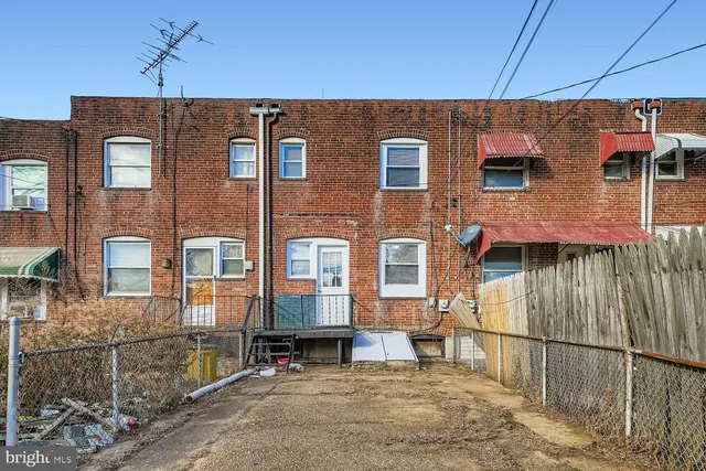 a view of a brick house with many windows