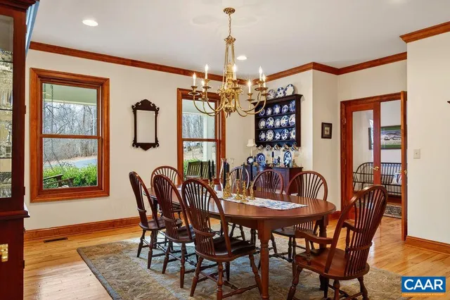 a view of a hallway with wooden floor and a potted plant