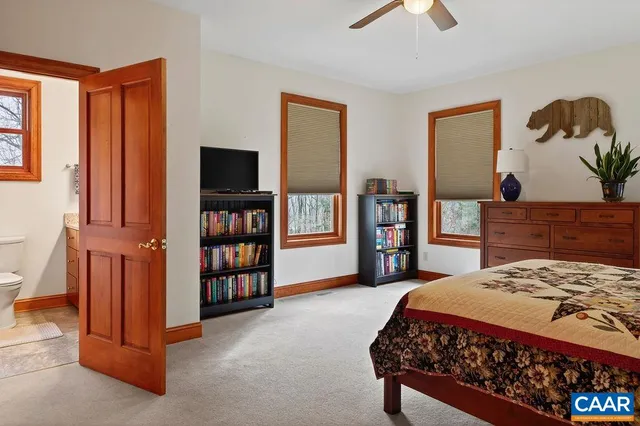 a bathroom with a granite countertop tub a sink and a large mirror