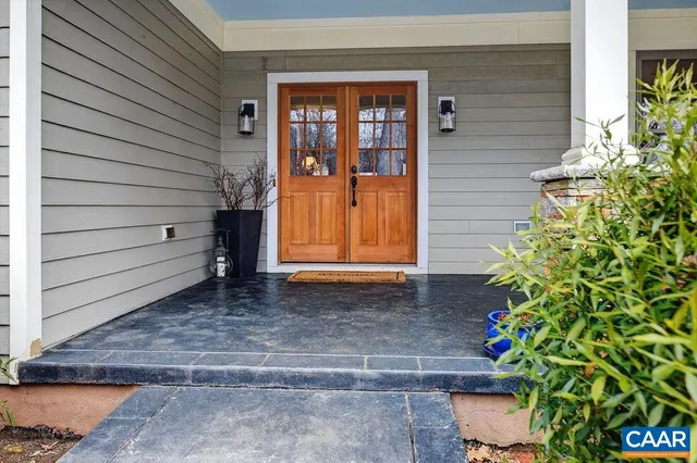 a living room with furniture a flat screen tv and kitchen view