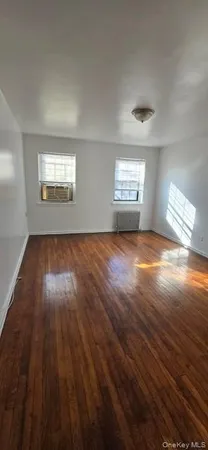 a view of room with wooden floor