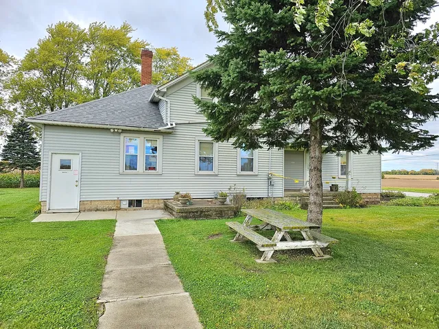a front view of a house with patio and garden