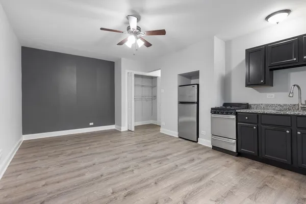a kitchen with stainless steel appliances granite countertop a refrigerator and a stove top oven