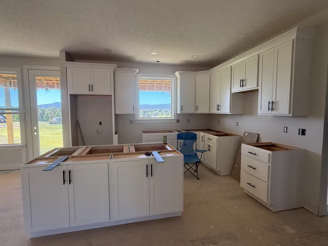 a kitchen with refrigerator and cabinets